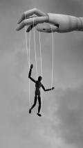 Wooden puppet controlled by strings symbolizing manipulation, codependency, addiction, and loss of personal control