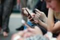 People using smartphones and mobile devices, illustrating digital addiction, excessive screen time, and social media use