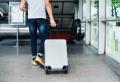 Person arriving with a suitcase at a treatment center for addiction recovery and a fresh start