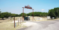 Entrance sign and driveway leading to Windmill Wellness Ranch addiction treatment center in Texas