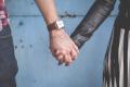Two people holding hands, symbolizing connection, trust, and supportive relationships