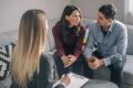 A couple speaking with a counselor during a session about addiction support and recovery