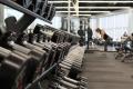 Dumbbells and fitness equipment inside a gym used for strength training and exercise