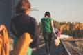 People walking along railroad tracks outdoors during a group activity, symbolizing personal growth, recovery, and moving forward