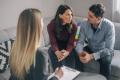 A couple speaking with a counselor during a session about addiction support and recovery
