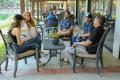 Group of people participating in an outdoor recovery support discussion at a treatment center