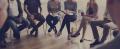 People seated in a circle during a group therapy or support group session