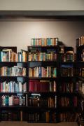 Bookshelf filled with recovery, wellness, and self-improvement books in a therapeutic treatment center setting
