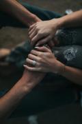 Several people placing their hands together in a gesture of support and unity
