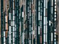 Aerial view of multiple freight trains and railcars lined up on parallel railway tracks