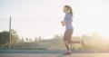 Woman jogging outdoors at sunrise as part of a healthy recovery lifestyle and wellness routine