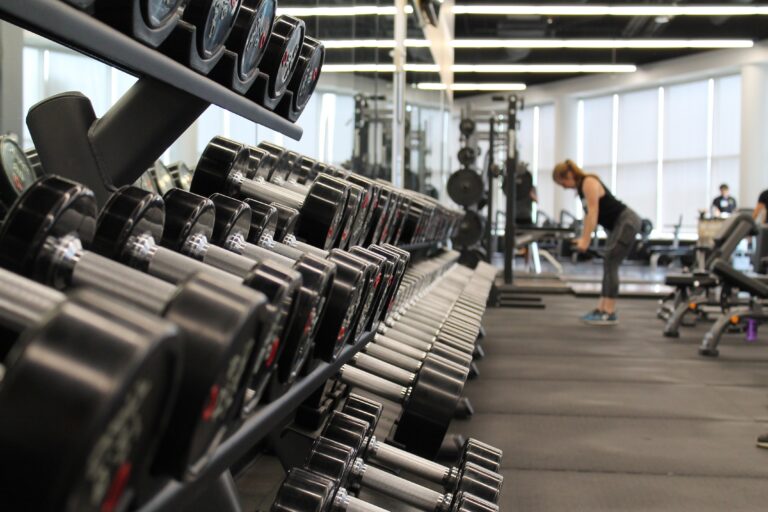 Dumbbells and fitness equipment inside a gym used for strength training and exercise