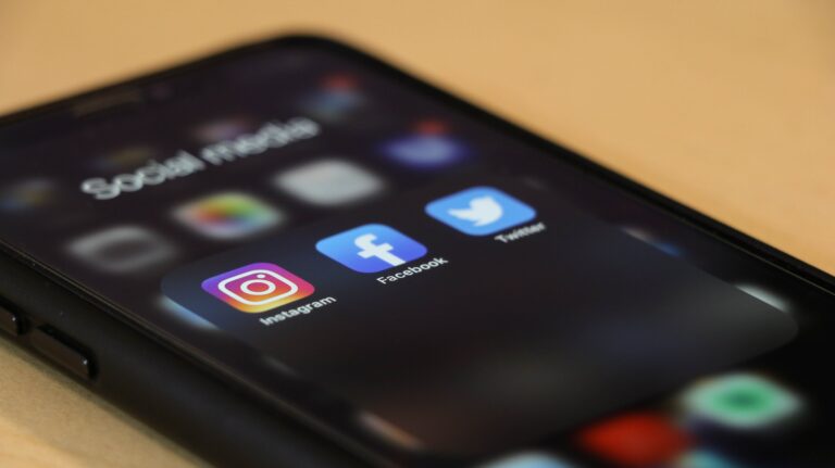 Smartphone screen displaying social media apps, including Instagram, Facebook, and Twitter, highlighting digital communication and online engagement