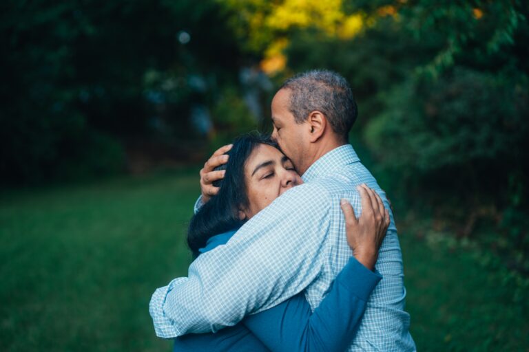 Two people embracing outdoors, showing family support and emotional connection during recovery