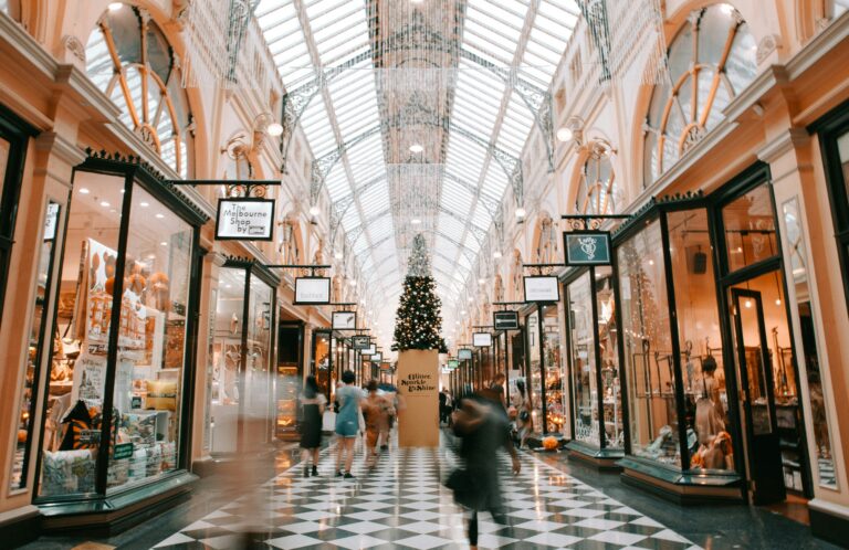 Busy shopping arcade decorated for the holidays, representing seasonal triggers and social pressures in recovery