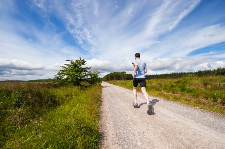 Person jogging on a rural trail to support physical health, mental wellness, recovery, and a healthy lifestyle