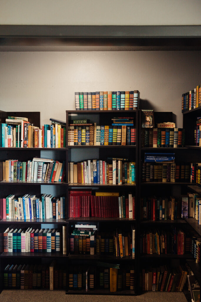Bookshelf filled with recovery, wellness, and self-improvement books in a therapeutic treatment center setting