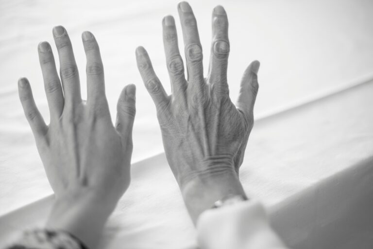 Two hands of different ages placed side by side, symbolizing aging, family connection, and generational relationships