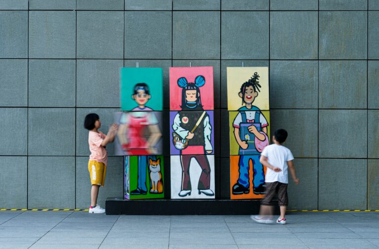 Children interacting with colorful character artwork in a creative and engaging public space