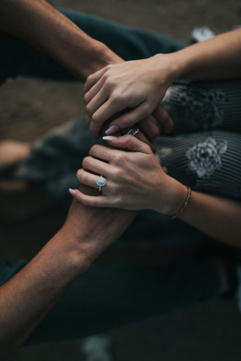 Several people placing their hands together in a gesture of support and unity