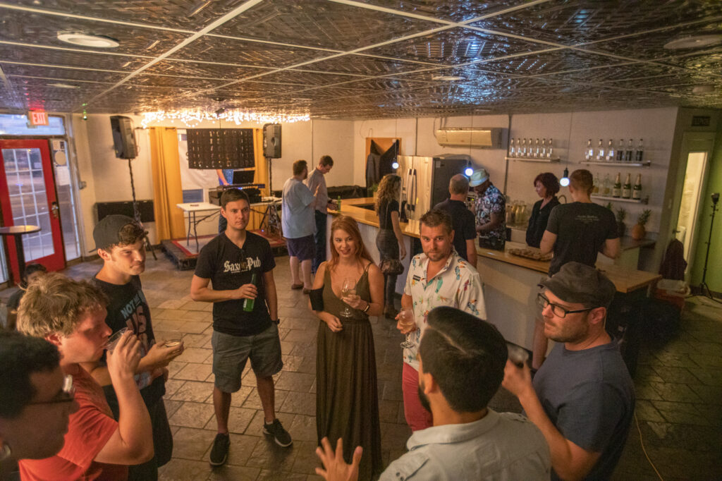 People socializing and enjoying non-alcoholic drinks at a sober social gathering
