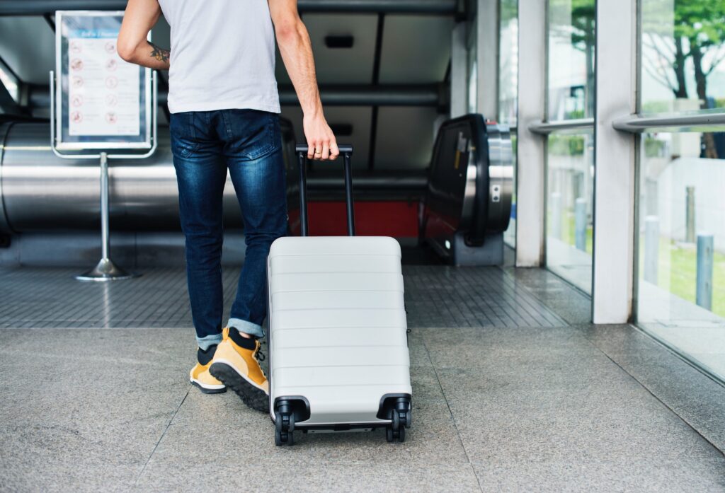 Person arriving with a suitcase at a treatment center for addiction recovery and a fresh start