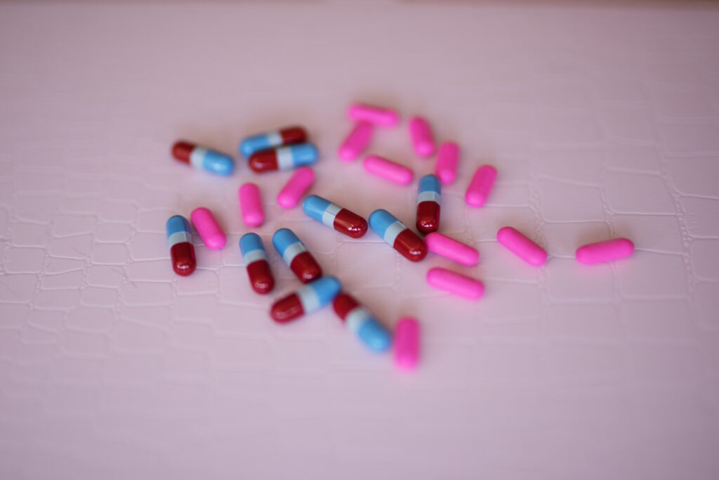 Assorted prescription pills and capsules on a surface representing medication misuse and substance abuse