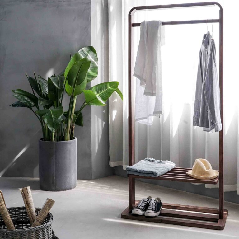 Minimalist room with neatly organized clothing, shoes, and natural light, representing healthy routines and daily structure