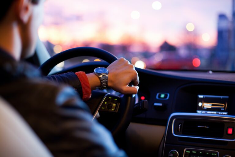 Person driving a car at dusk, representing responsible decision-making, recovery, and everyday life after treatment