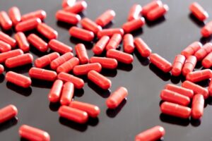 Red capsules representing ZaZa and tianeptine products known as gas station heroin